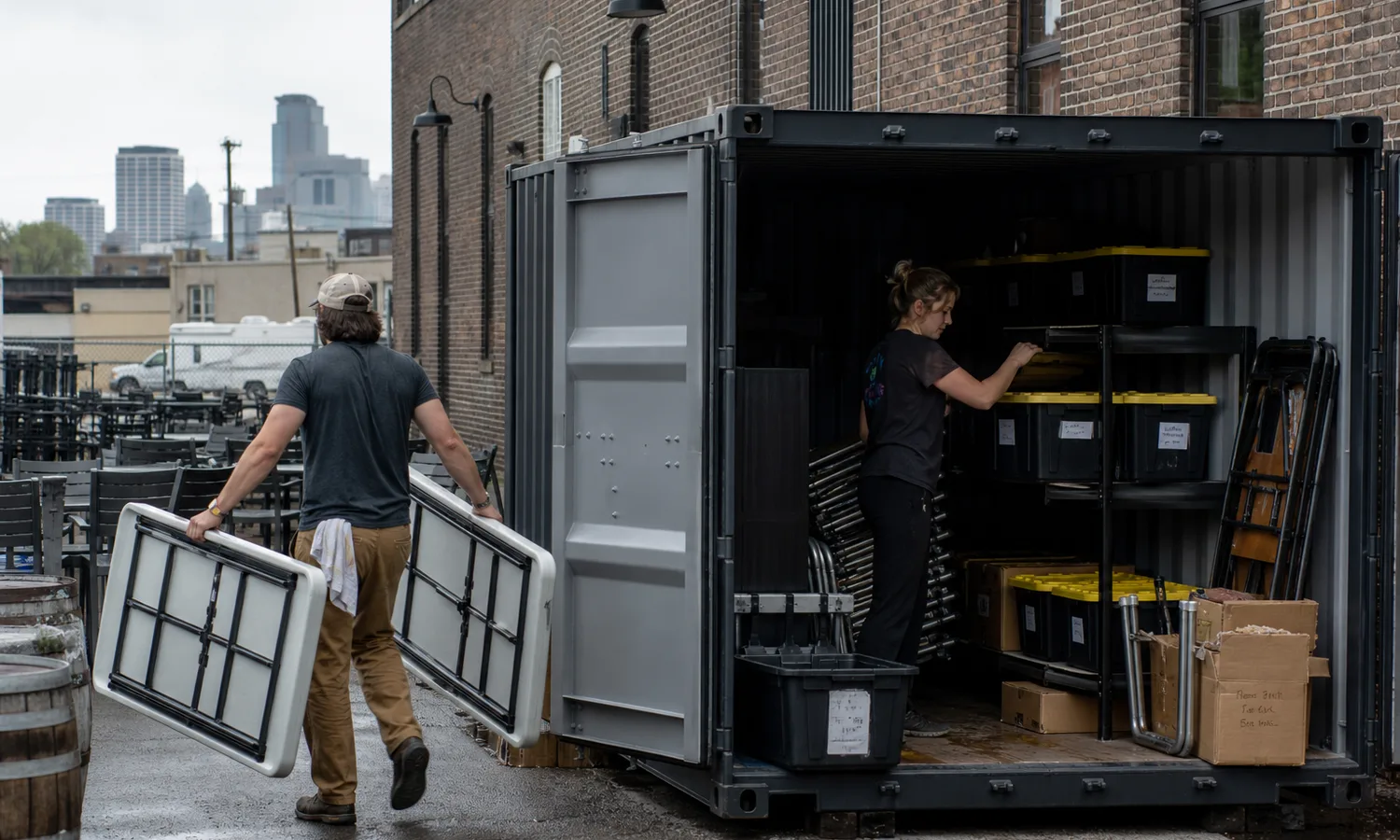 Minneapolis brewery staff organizing seasonal equipment in a steel shipping container